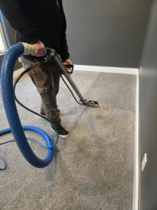 Hot water extraction cleaning of carpet with a wand and solution hose