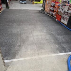 Commercial hard floor being cleaned in a retail aisle