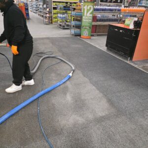Technician operating a floor cleaning machine in a commercial building