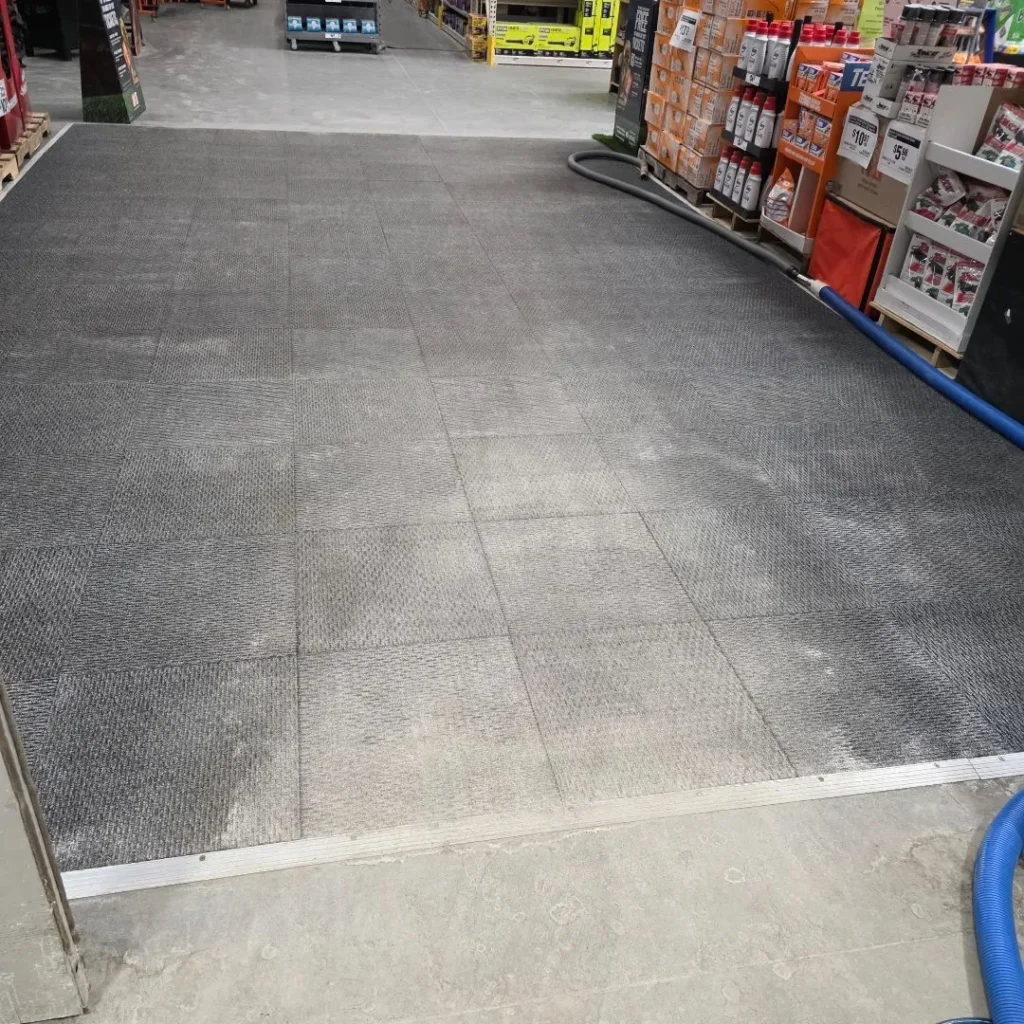 Commercial hard floor being cleaned in a retail aisle